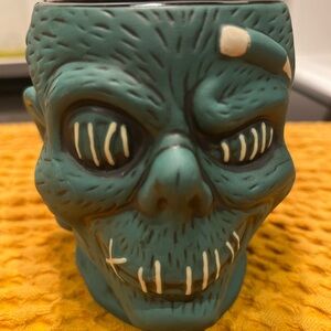 Disney hotel Trader Sam’s shrunken head and Tiki glass.